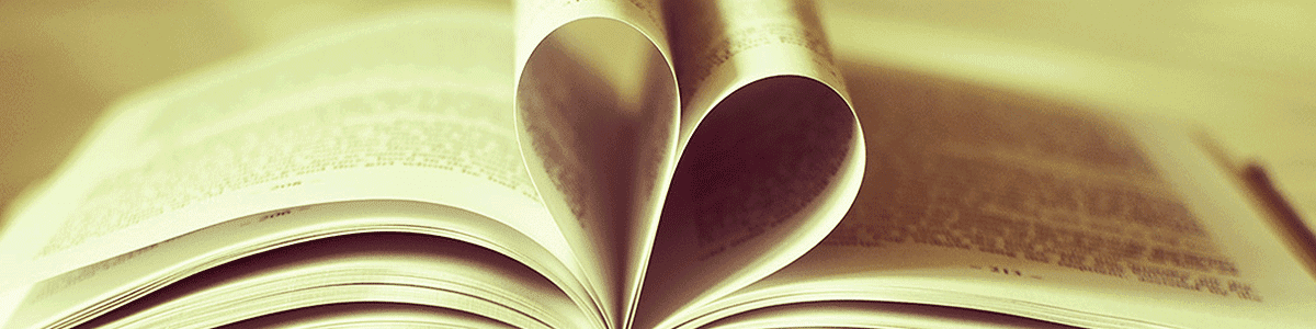 Open book with pages folded into a heart shape, representing reading and love of books